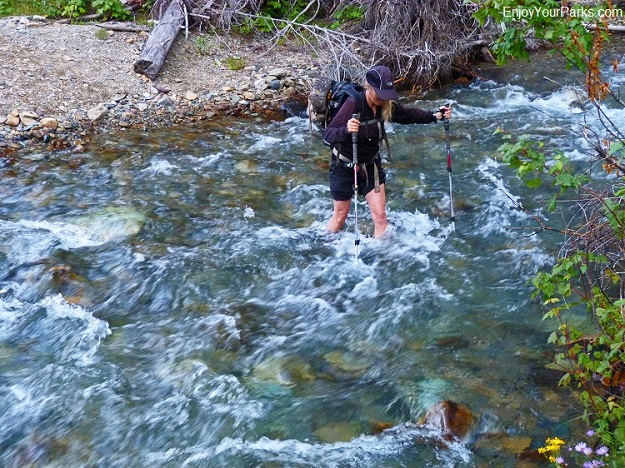 Shannon crossing a creek in river sandals.