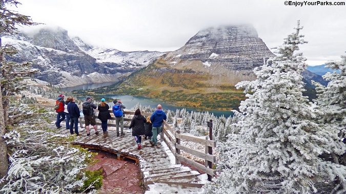 Hikers enjoying the Hidden Lake Overlook on Logan Pass during a fall in Glacier National Park.