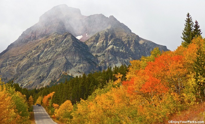 Two Medicine Road with Rising Wolf Mountain towering over it during an Autumn (Fall) in Glacier Park.
