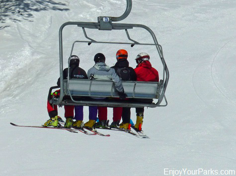 Skiers riding a chair lift at Big Sky Resort Montana