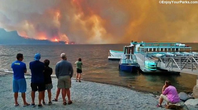 Visitors watching the Howe Ridge Fire from the shore at Lake McDonald Lodge